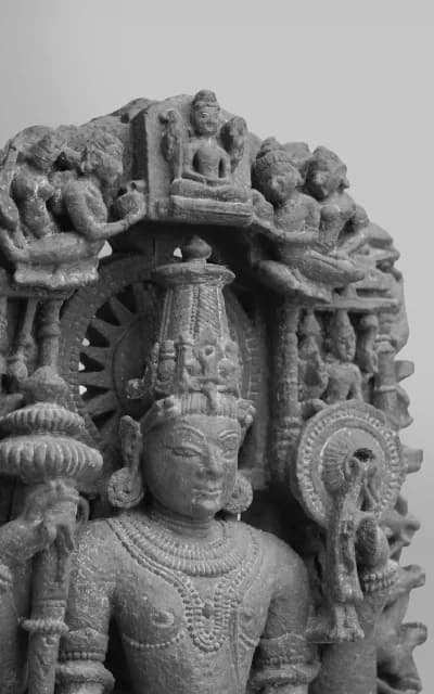 A close-up, three-quarter view of a bronze Shiva Nataraja statue, highlighting the intricate facial features and traditional headdress.