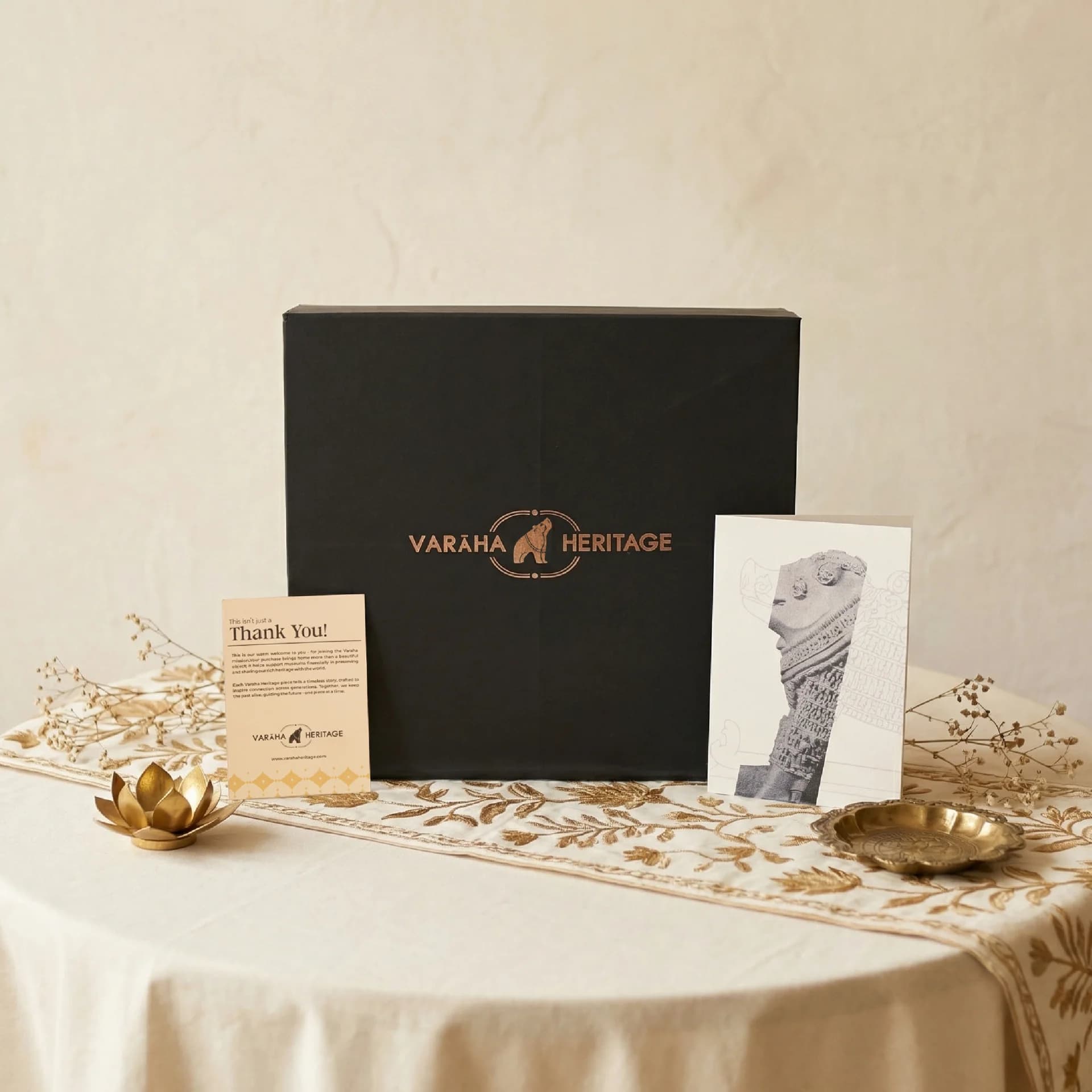 A black gift box containing the Adi Varaha Sculpture replica, displayed with a thank you card and informational print.