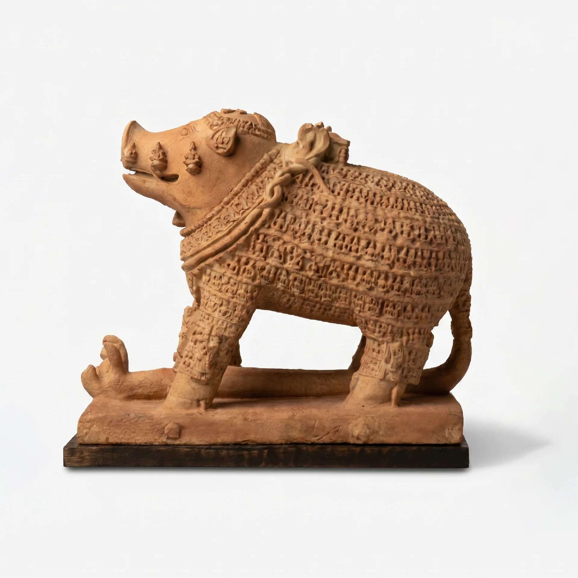 A full side profile of the Adi Varaha Sculpture, a terracotta-style replica showing intricate carvings of the boar avatar.