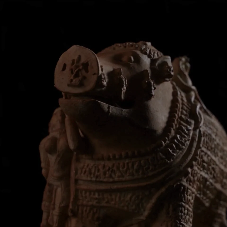 A dramatic low-angle closeup of the Adi Varaha Sculpture, highlighting the intricate stone-carved textures of the divine boar avatar.