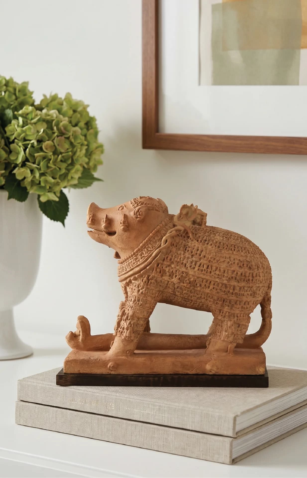 A side profile view of the Adi Varaha Sculpture, a terracotta-style replica featuring intricate carvings of the boar deity.