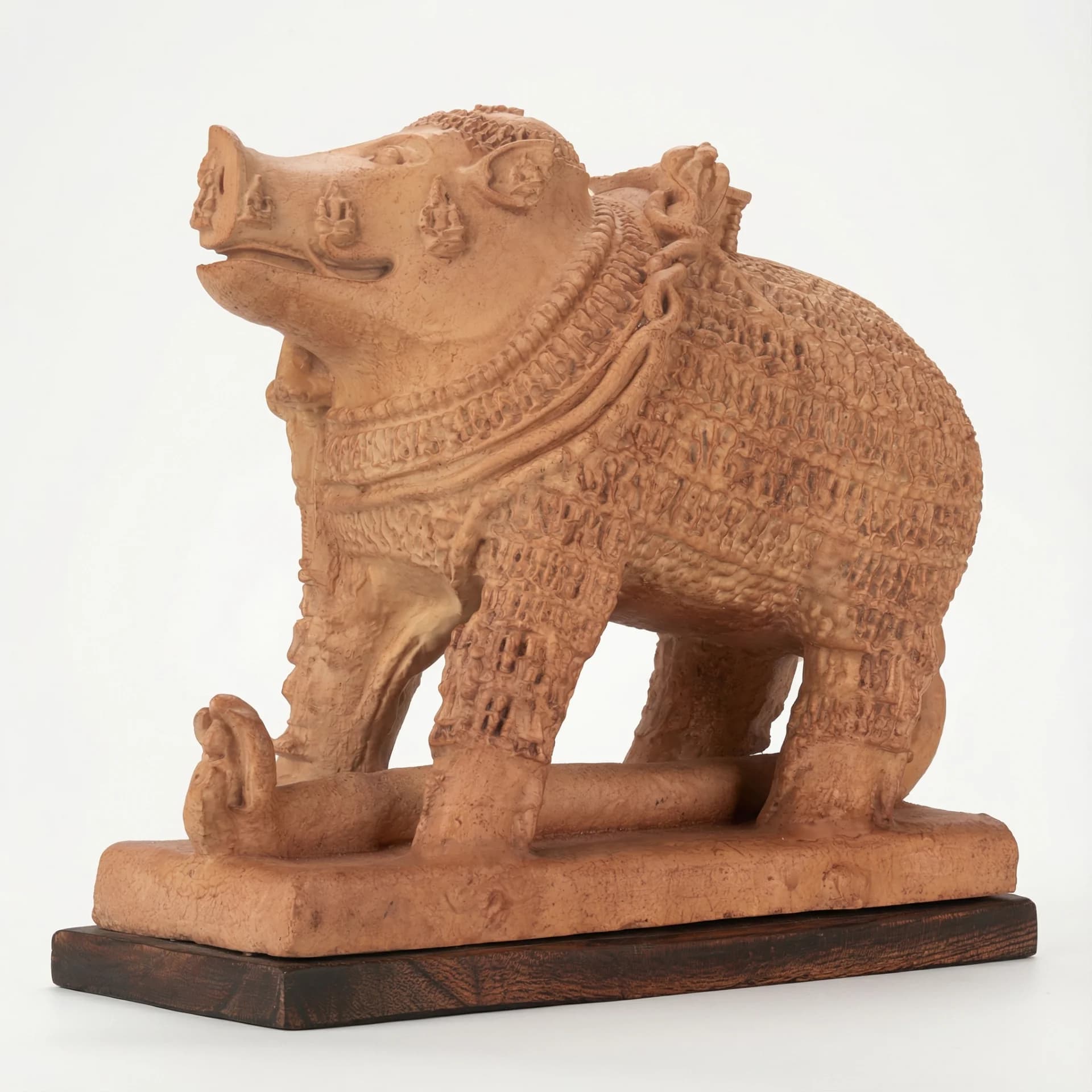 Side view of the Adi Varaha Sculpture, a terracotta-style museum replica showing intricate carvings of the boar-headed Vishnu avatar.