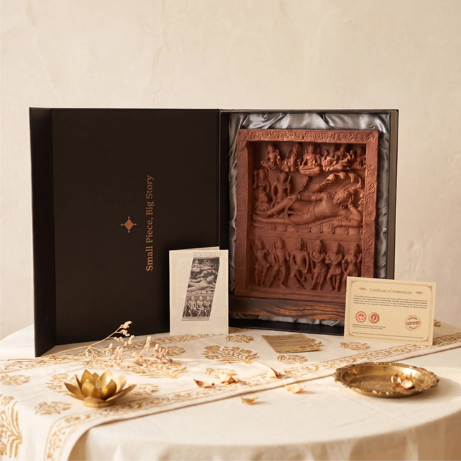 An Anantasayana Vishnu Sculpture replica presented in a black gift box with a certificate of authenticity and informational card.