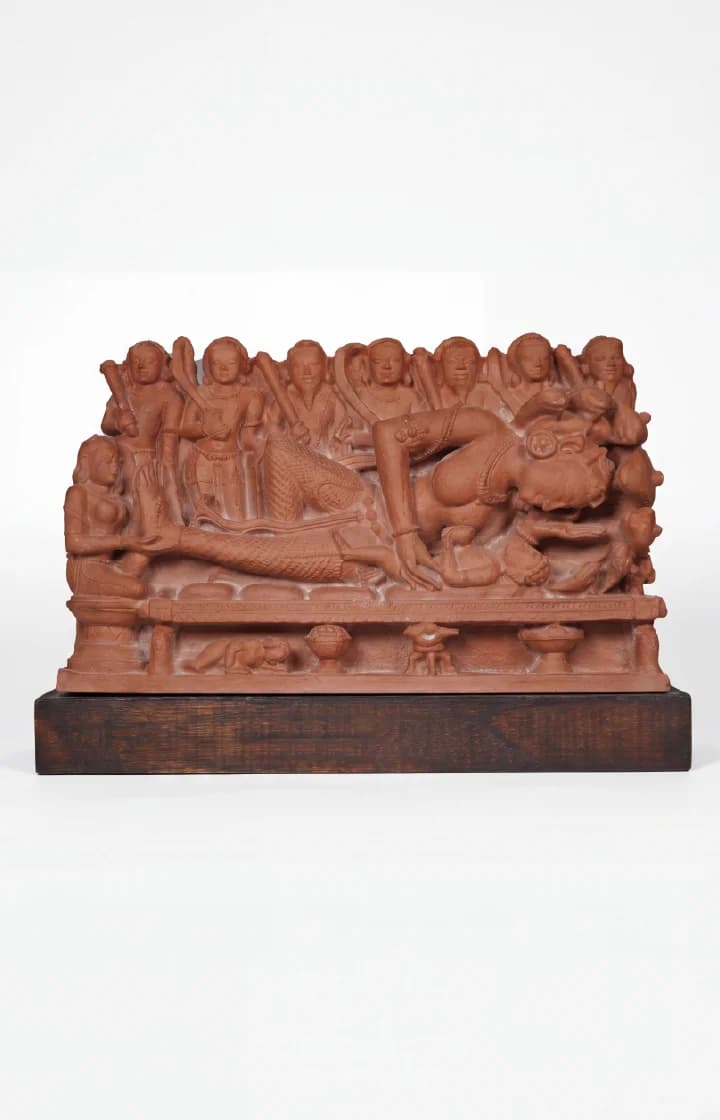 A museum-grade terracotta replica of Krishna's Birth Sculpture, showing Devaki and guards in intricate 10th-century relief detail.