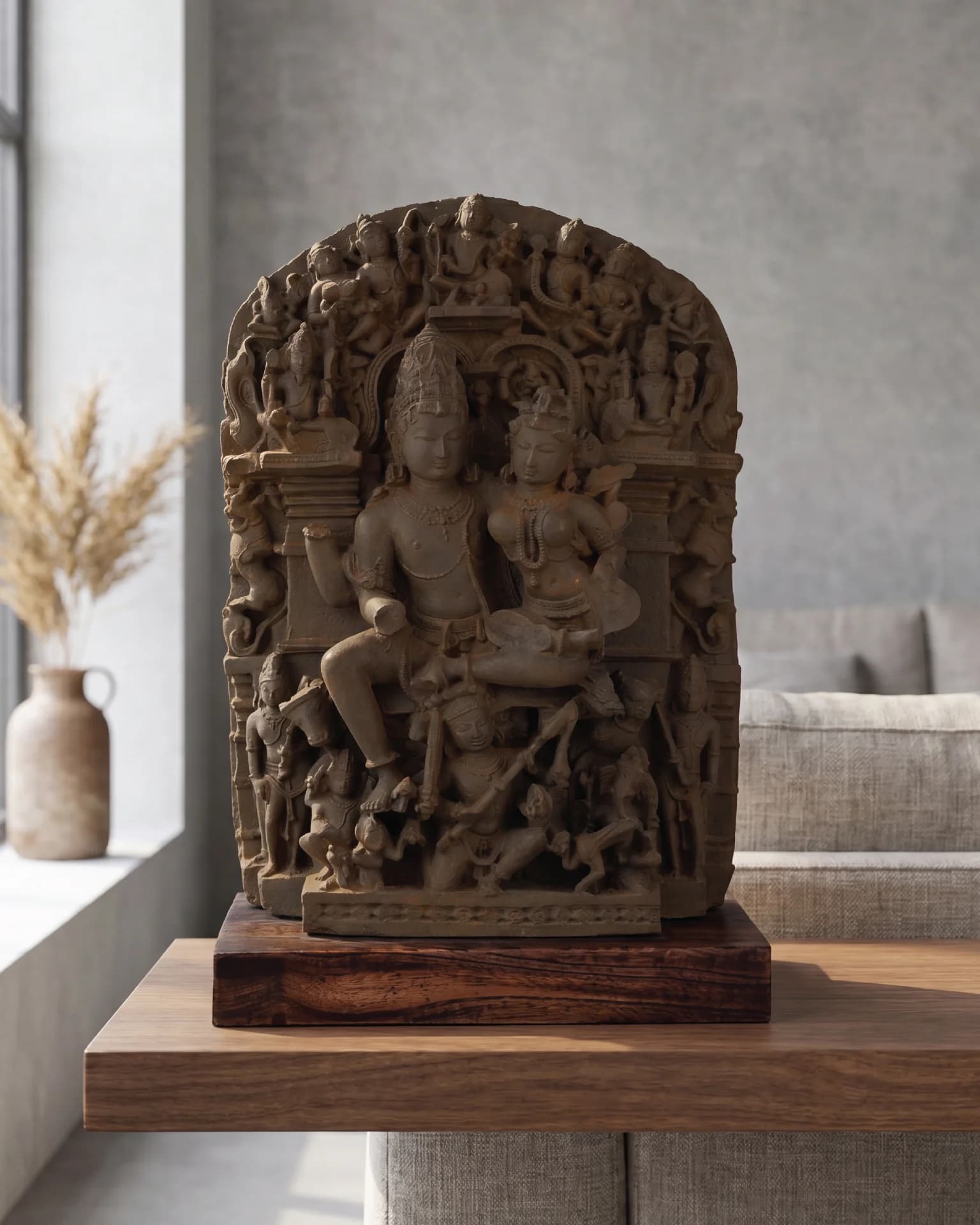 A front-facing view of the Ravananugraha Sculpture, a detailed stone composite replica featuring intricate carvings mounted on a dark teak base.