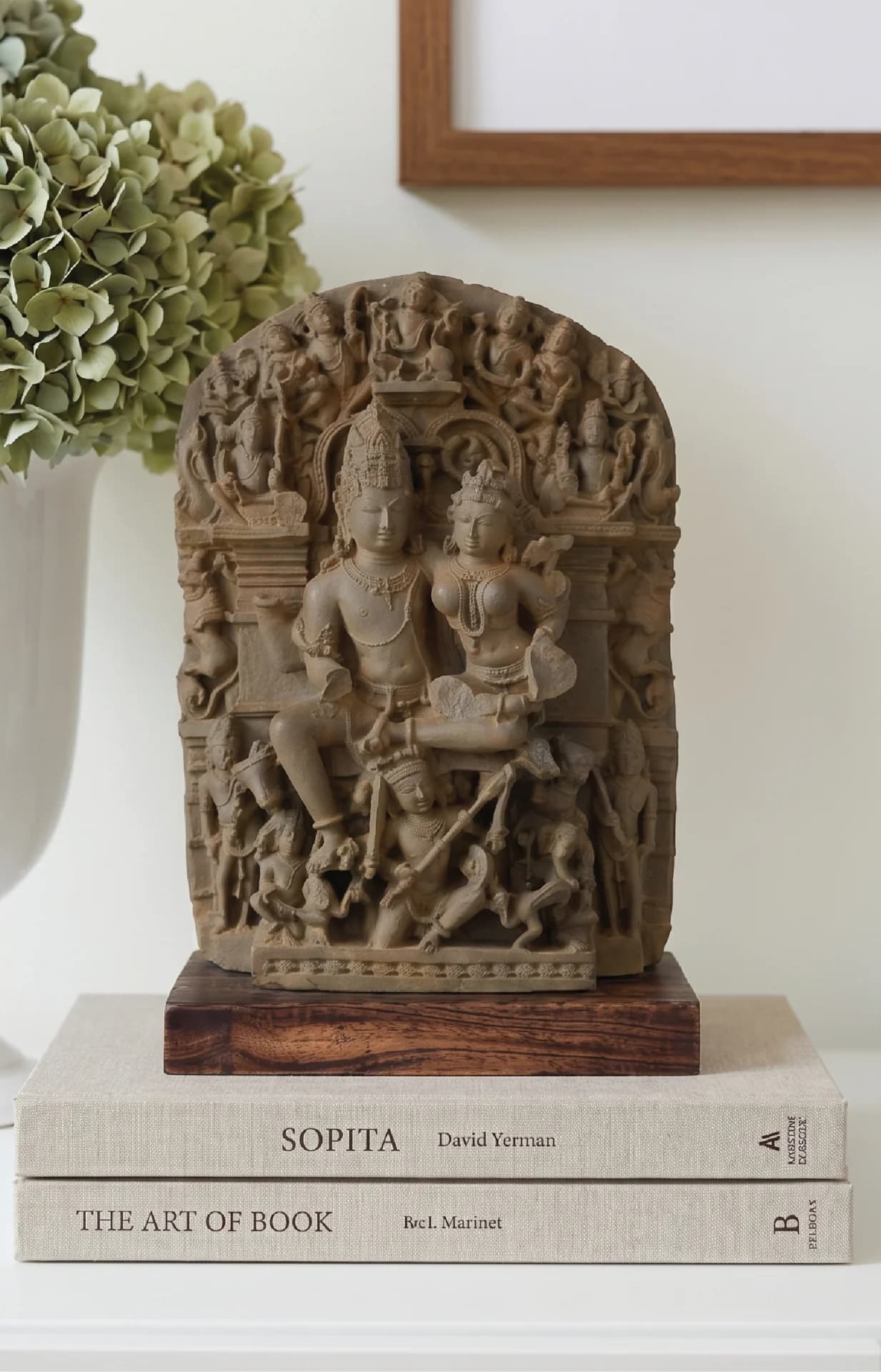 A front-facing view of the Ravananugraha Sculpture, a stone composite replica featuring intricate carvings of Shiva and Parvati.