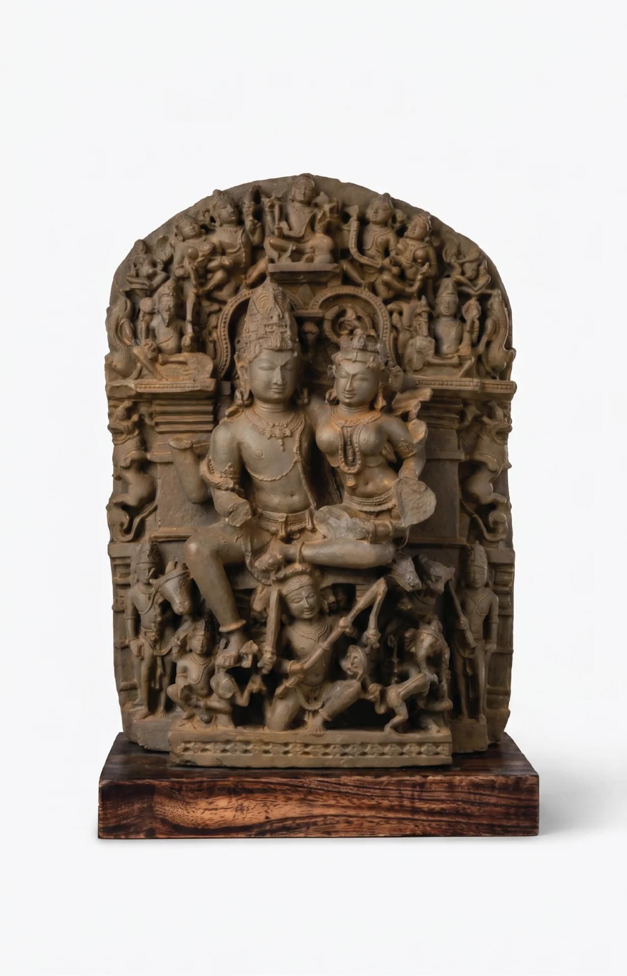 A full front view of the Ravananugraha Sculpture, a hand-finished stone composite replica featuring Shiva and Parvati mounted on a teak base.