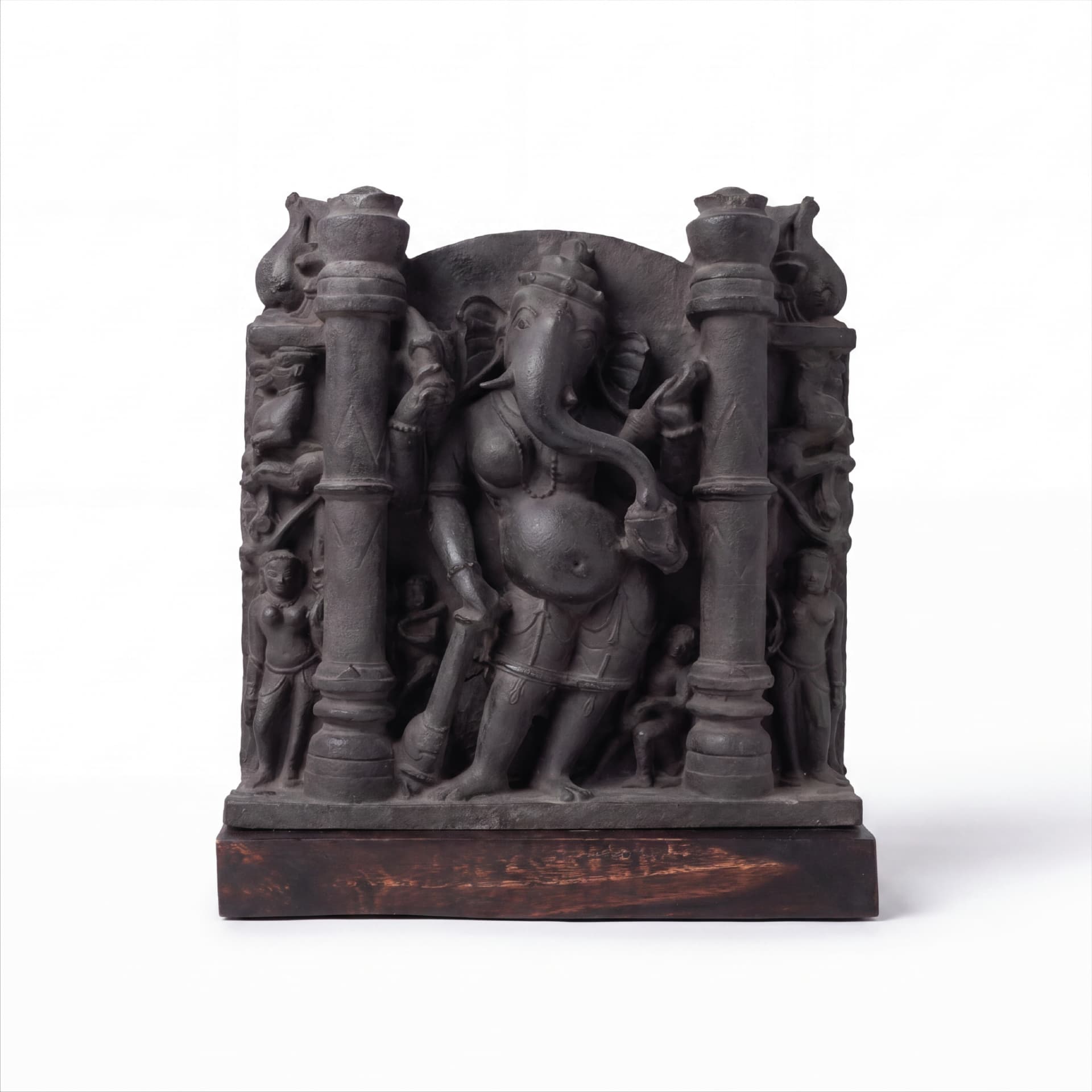 A museum-grade Vinayaki Sculpture replica in dark stone, featuring intricate temple carvings of the elephant-headed deity standing between pillars.