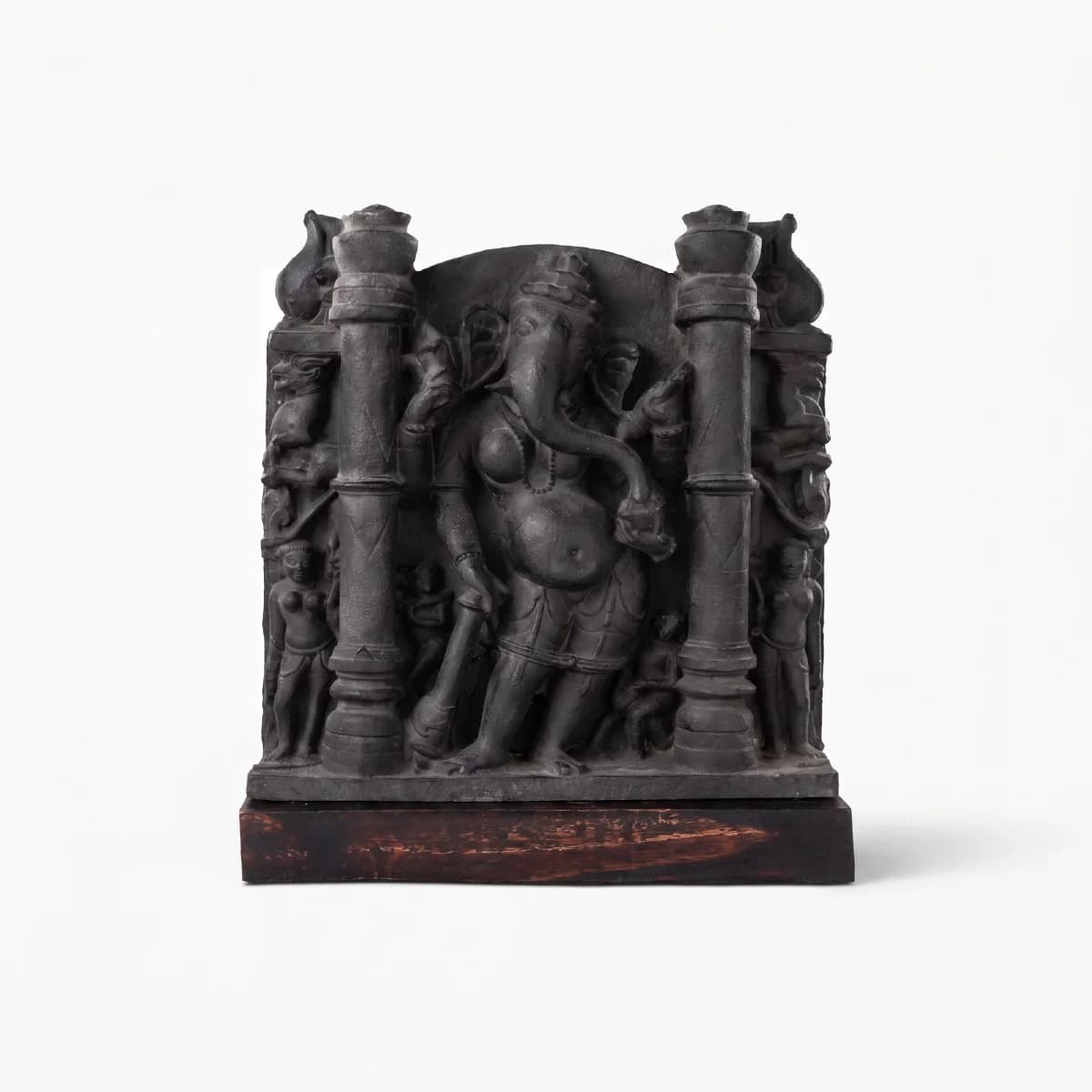 A museum-grade Vinayaki Sculpture replica in dark stone, featuring intricate temple carvings of the elephant-headed deity standing between pillars.