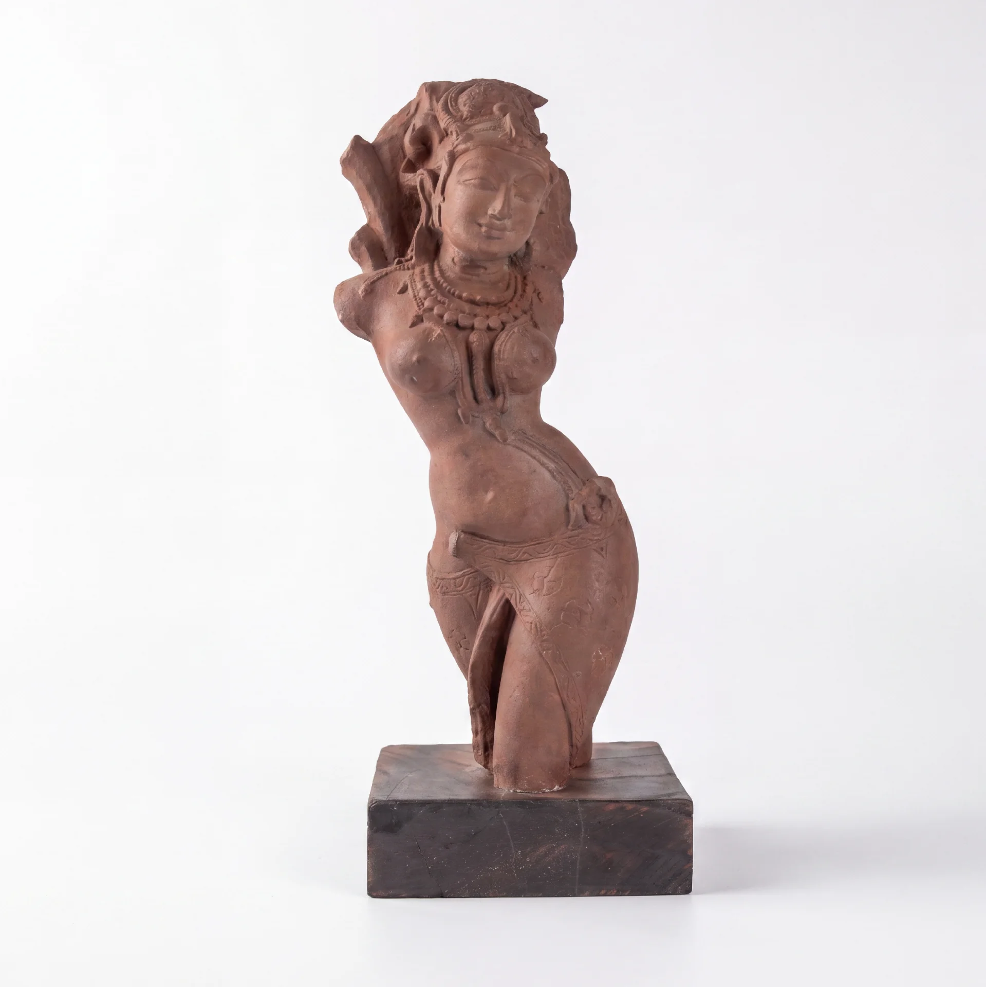 A full front view of the Salabhanjika Sculpture, a stone composite replica featuring an elegant tribhanga pose on a wooden base.