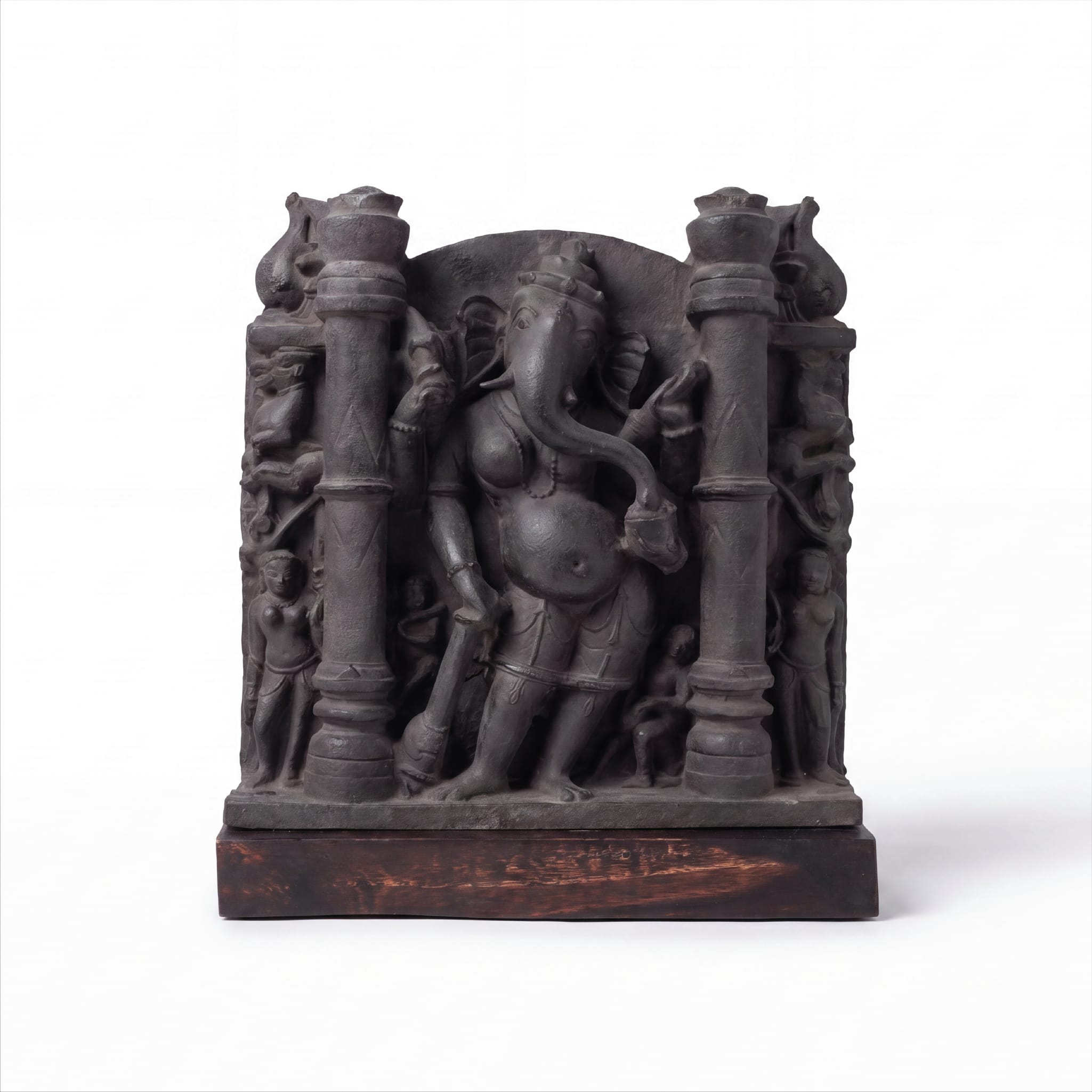 A museum-grade Vinayaki Sculpture replica in dark stone, featuring intricate temple carvings of the elephant-headed deity standing between pillars.