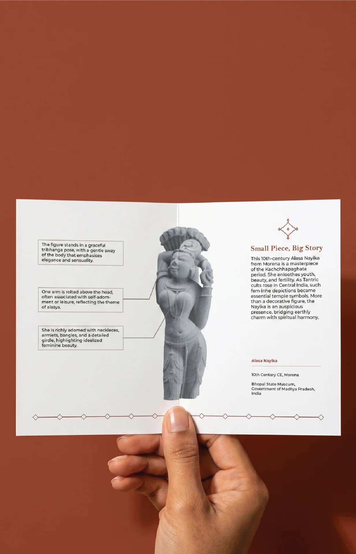 A hand holds an informational card featuring the Alasa Nayika Sculpture, a finely carved stone replica showing a celestial figure.