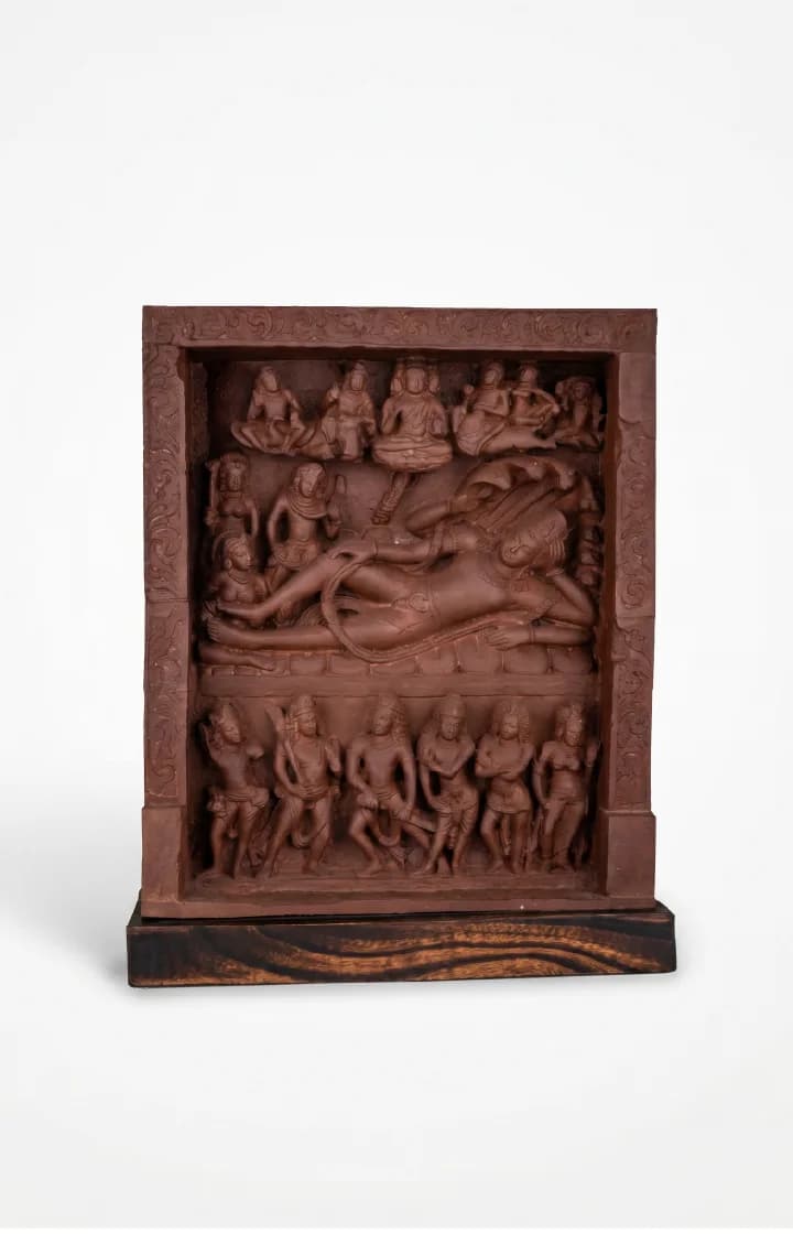 A front-facing view of the Anantasayana Vishnu Sculpture, featuring intricate terracotta-style relief carvings of deities resting on a wooden base.