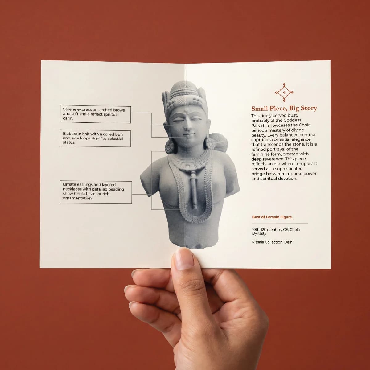 A hand holds an informational brochure featuring the Female Figure Bust Sculpture with detailed annotations on Chola style craftsmanship.
