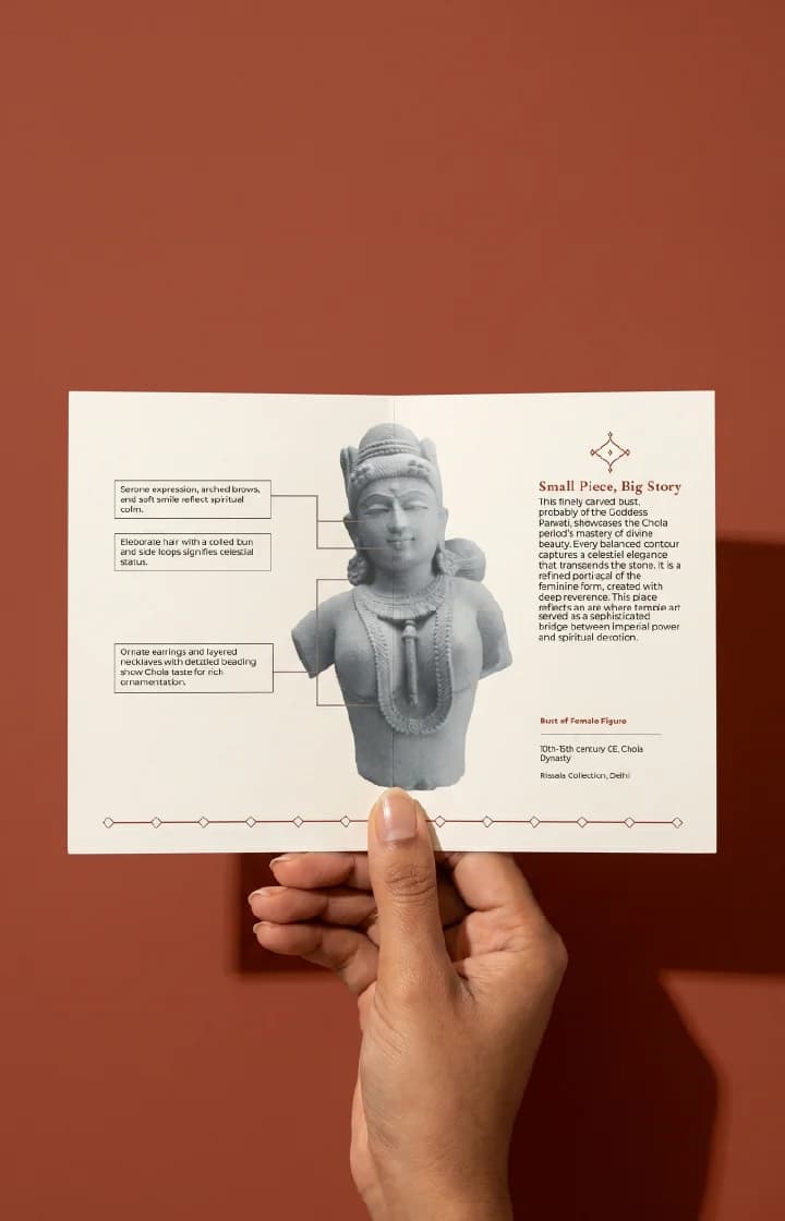 A hand holds an informational card featuring the Female Figure Bust Sculpture, highlighting Chola style details and historical context.