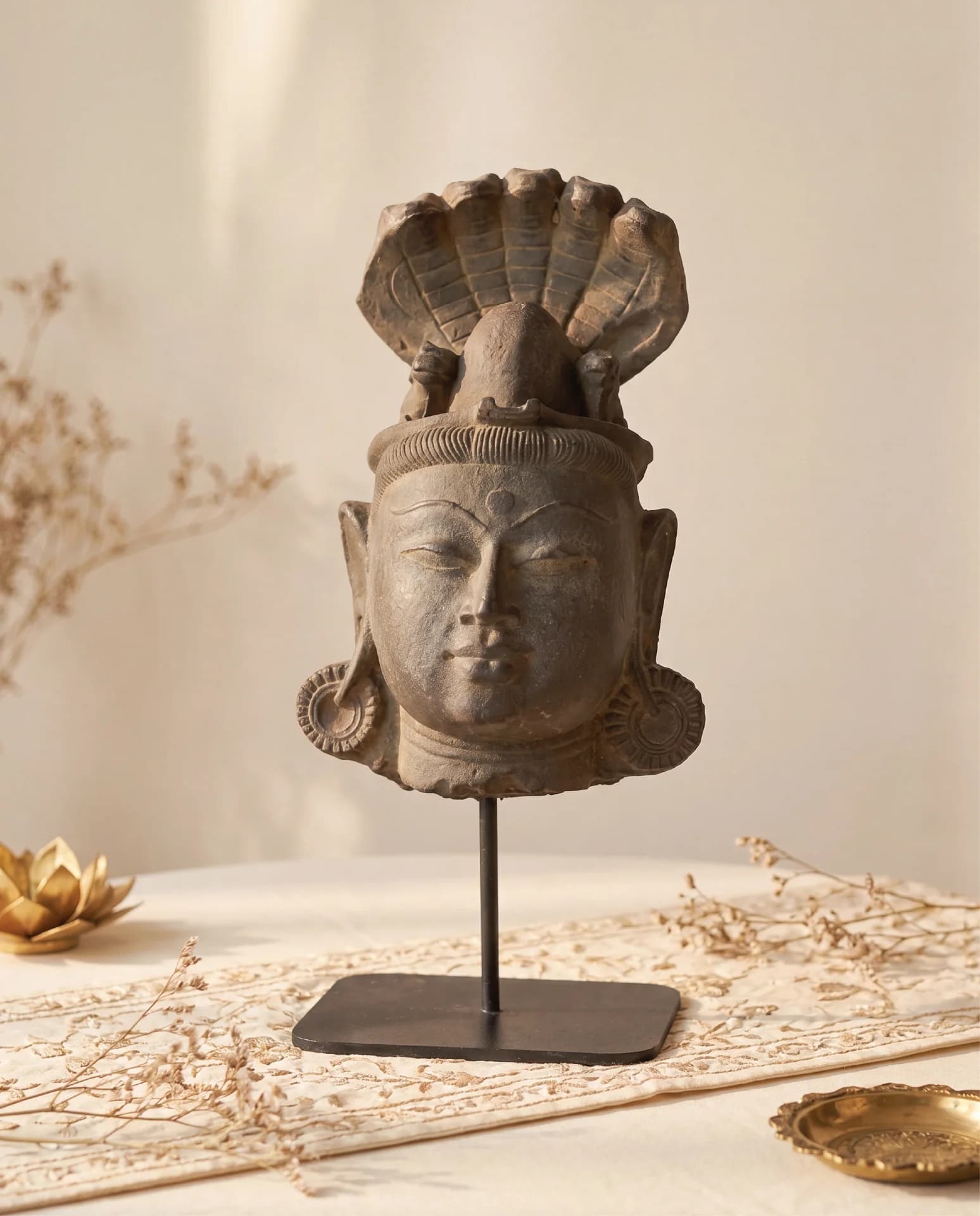 A front-facing view of the Shiva Lingam with Nandi & Serpent replica, featuring a serene stone composite head sculpture.