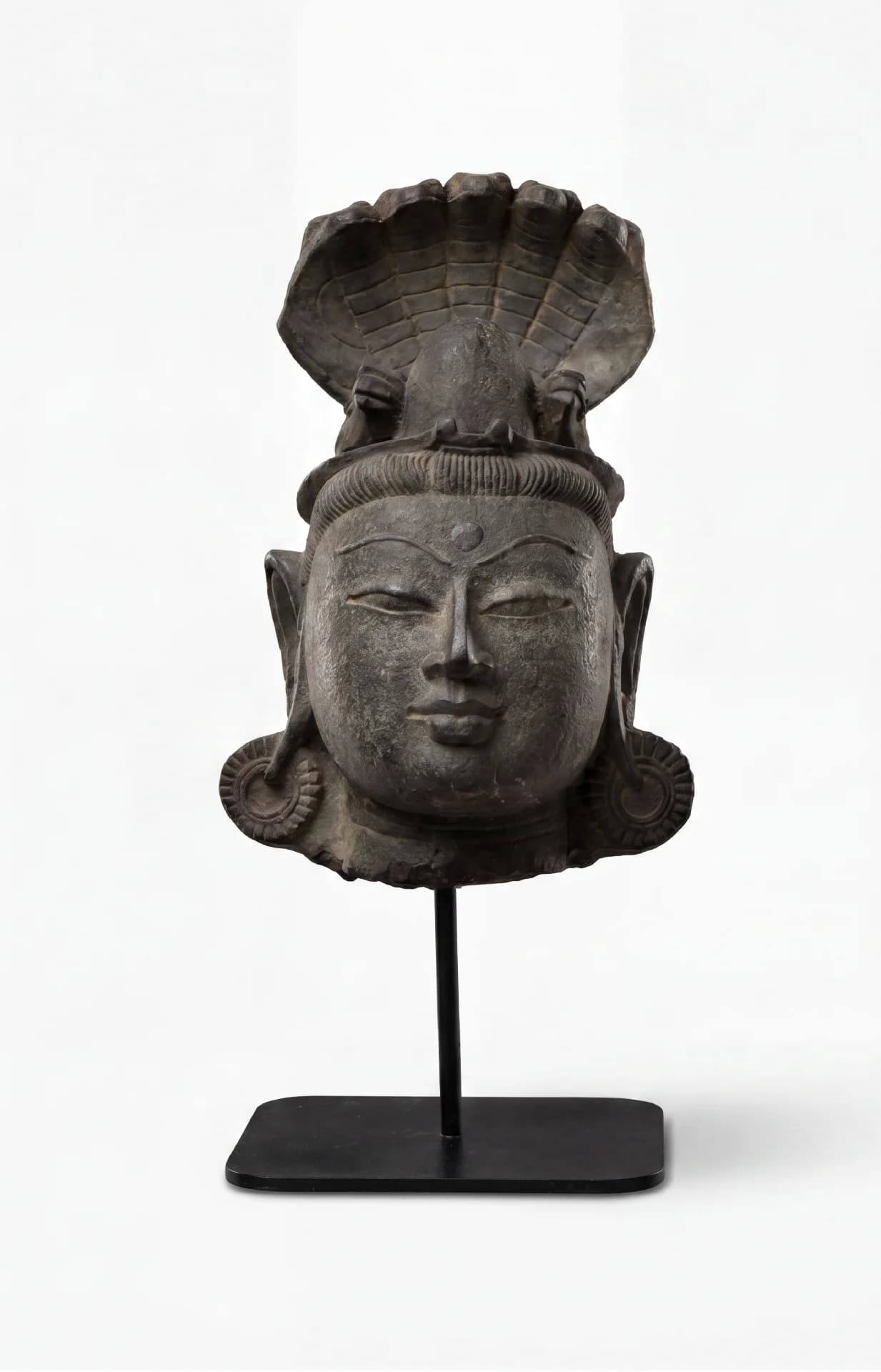 A front view of the Shiva Lingam with Nandi & Serpent replica, featuring a serene stone composite head sculpture.