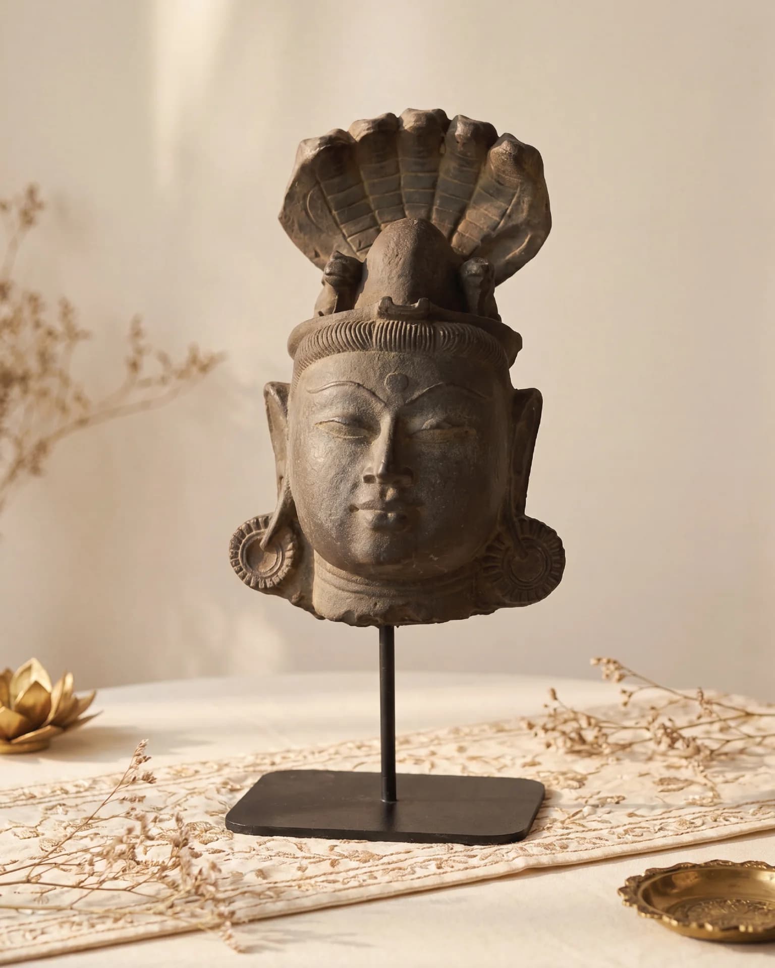A front-facing view of the Shiva Lingam with Nandi & Serpent replica, featuring intricate stone composite carving on a stand.