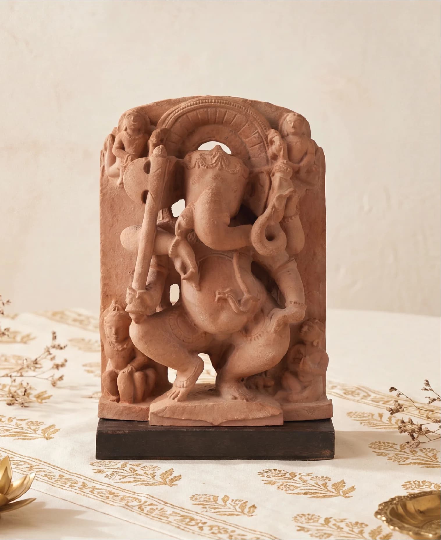 A front-facing view of the Ganesha Sculpture, a handcrafted terracotta-style replica featuring intricate temple art details on a wooden base.