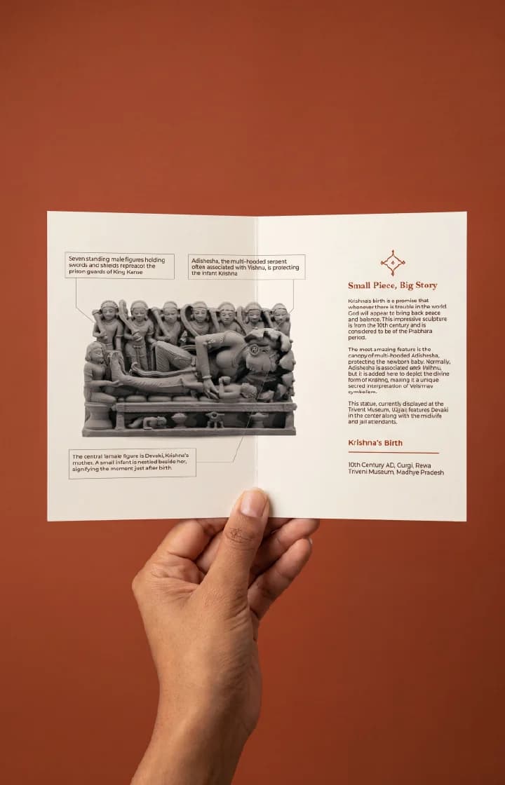 A hand holds an informational brochure featuring the Krishna's Birth Sculpture, a detailed stone-finish museum replica with historical annotations.
