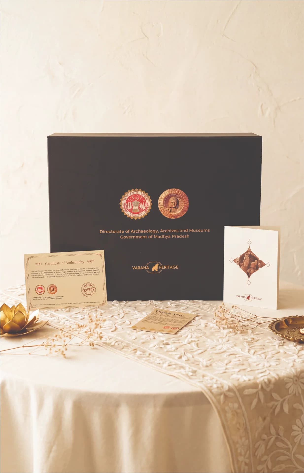 The Lakshmi Narayan Sculpture packaging box displayed with its official certificate of authenticity and a heritage brand greeting card.