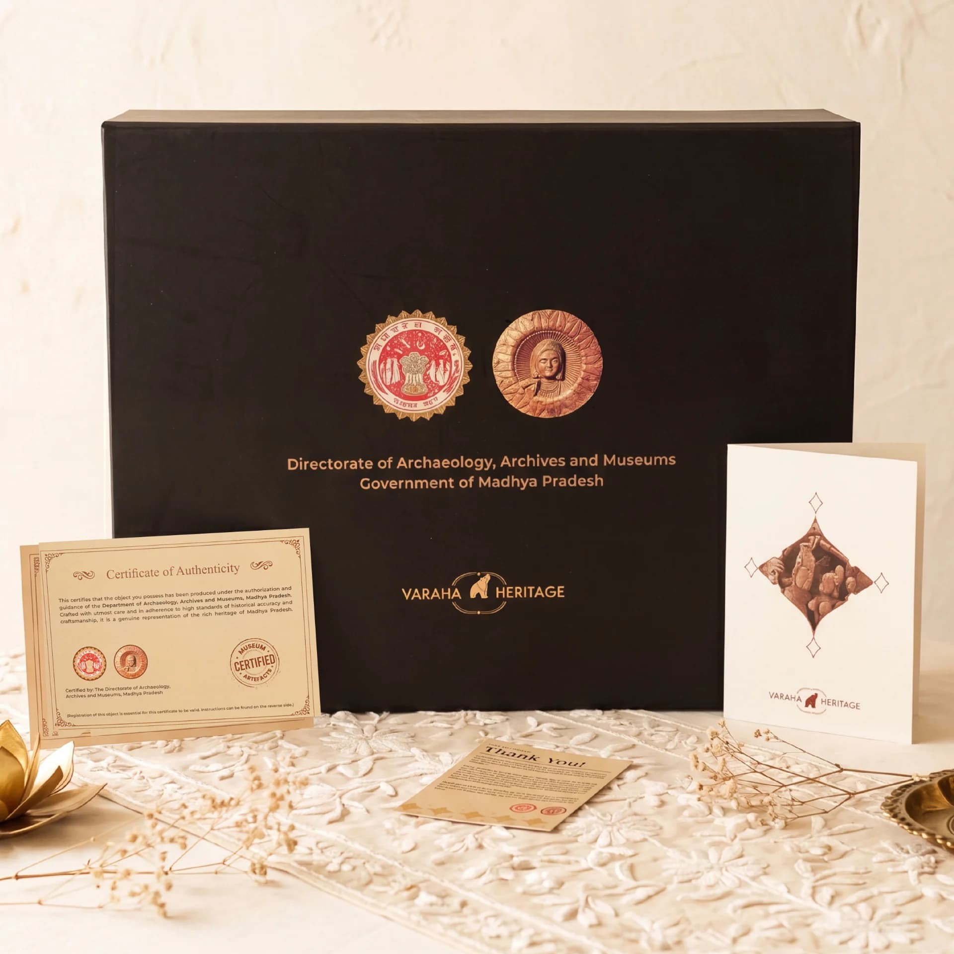 The Lakshmi Narayan Sculpture packaging box displayed with its official certificate of authenticity and a branded information card.