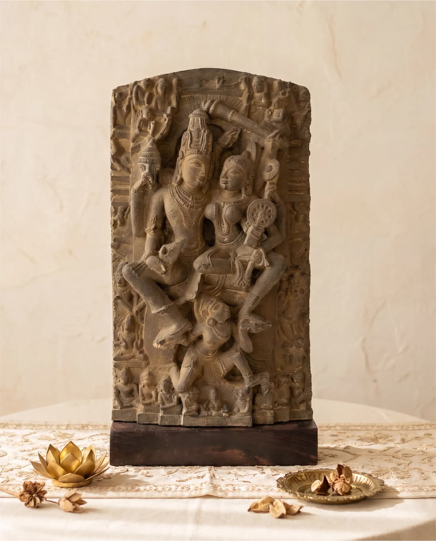 A front-facing view of the Lakshmi Narayan Sculpture, a hand-finished stone replica featuring intricate 12th-century style carvings on a wooden base.