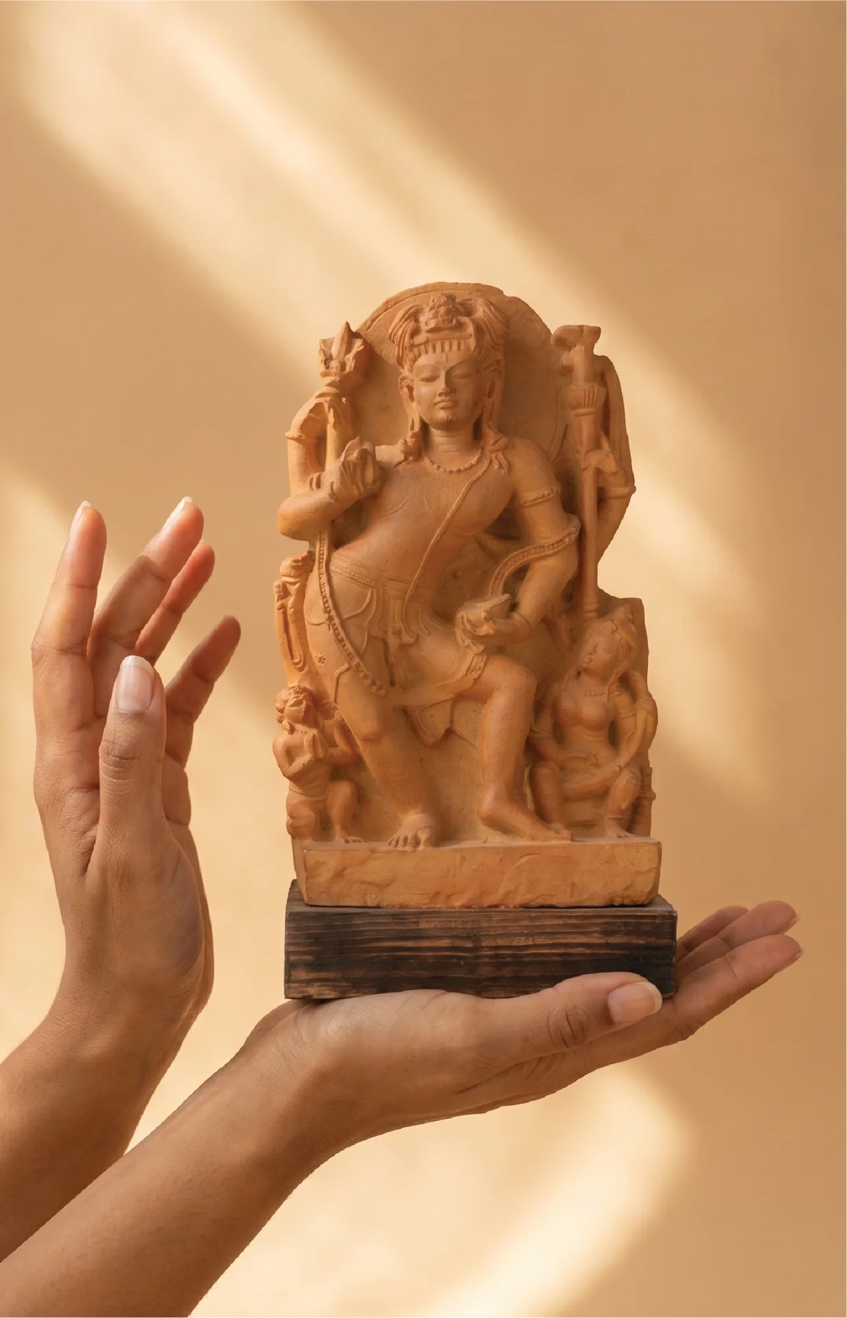 A pair of hands gently cradles the Natesh Shiva Sculpture, a detailed stone composite replica of the 8th-century Pratihara masterpiece.