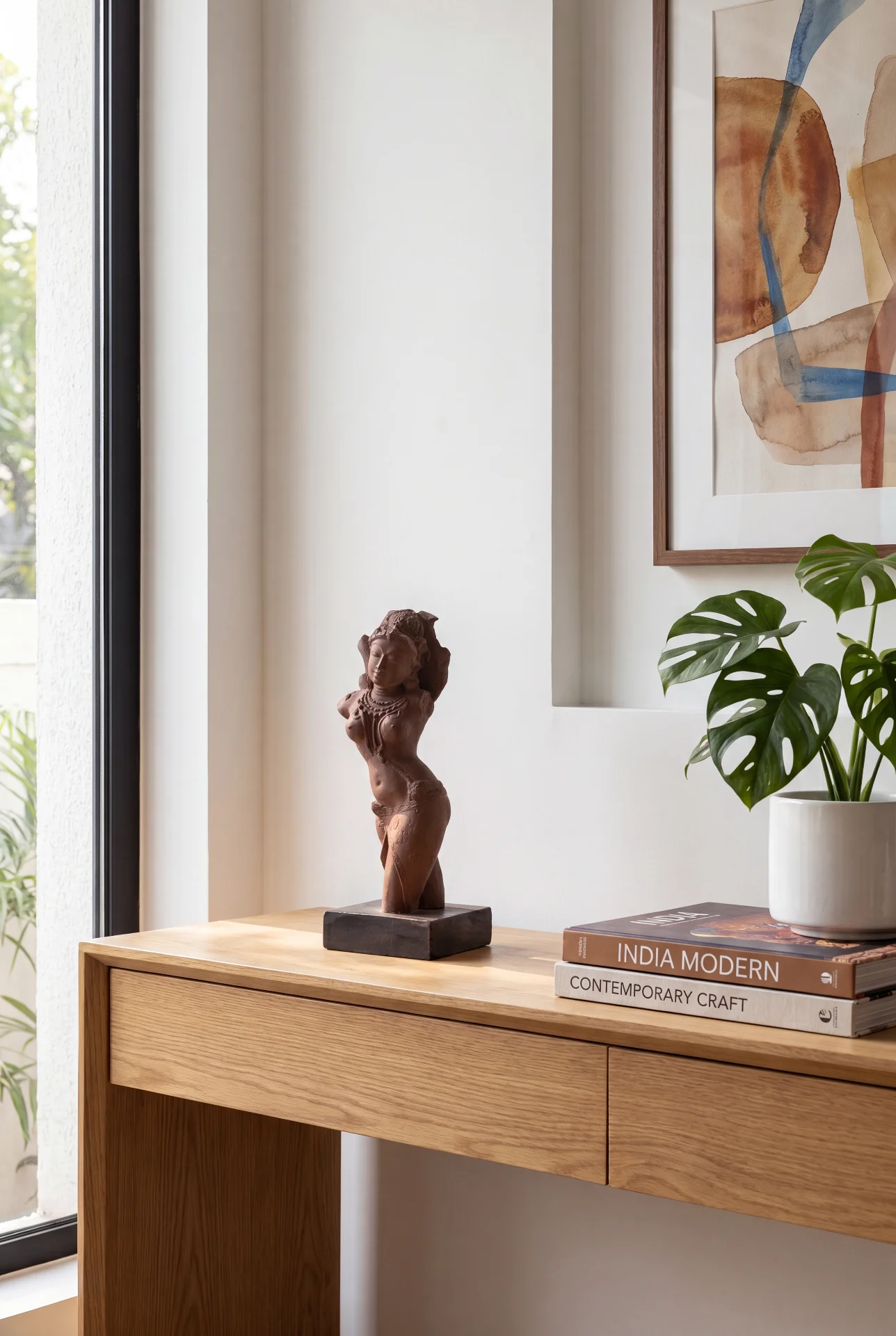 A Salabhanjika Sculpture displayed on a wooden console table, showcasing its elegant stone composite finish in a modern home setting.